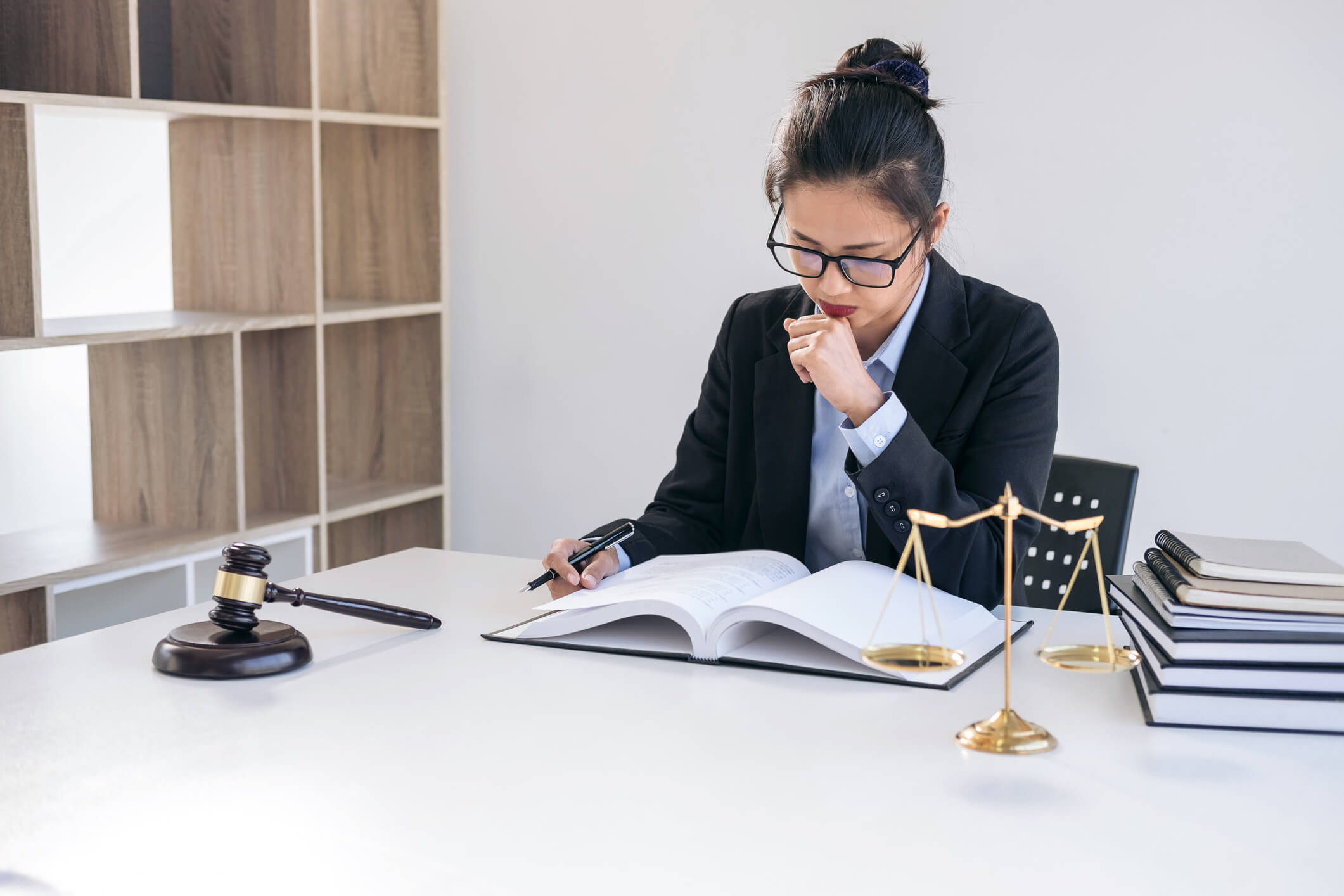 Judge gavel with scales of justice, professional female lawyers working having at law firm in office. Concepts of law